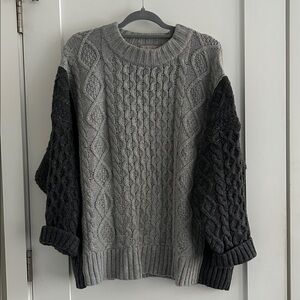 J. Crew oversized cable-knit crewneck sweater with contrast sleeves.